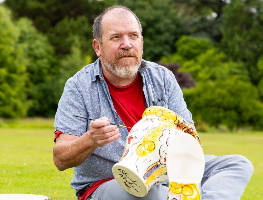 Charlie Mahon painting his irish Ceramics Creation