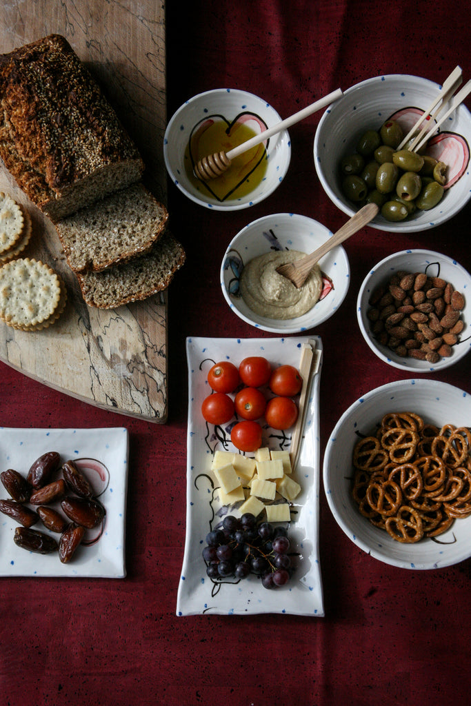 Selection of small bowls and ramekins and serving plates that compliment each other and are great for serving party food.