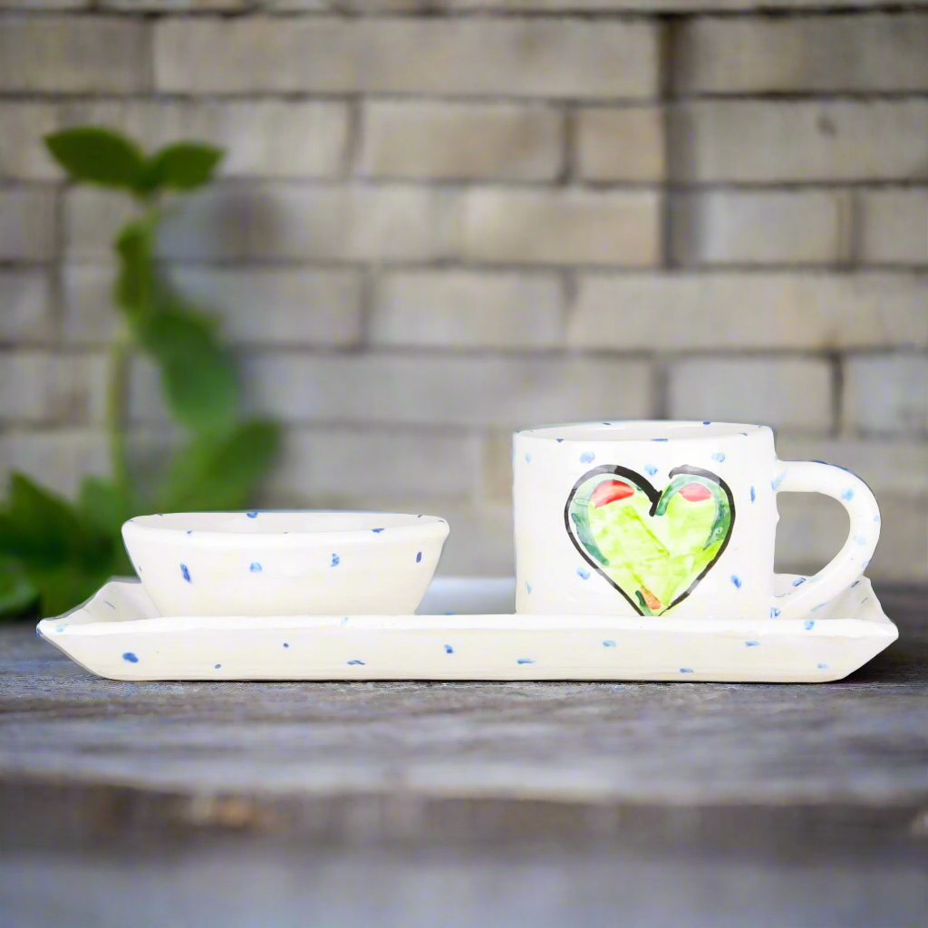 stunning pottery gift of a breakfast tea set with mug and serving plate with dipping bowl all hand painted with beautiful green hearts on a white glaze and periodic blue dots