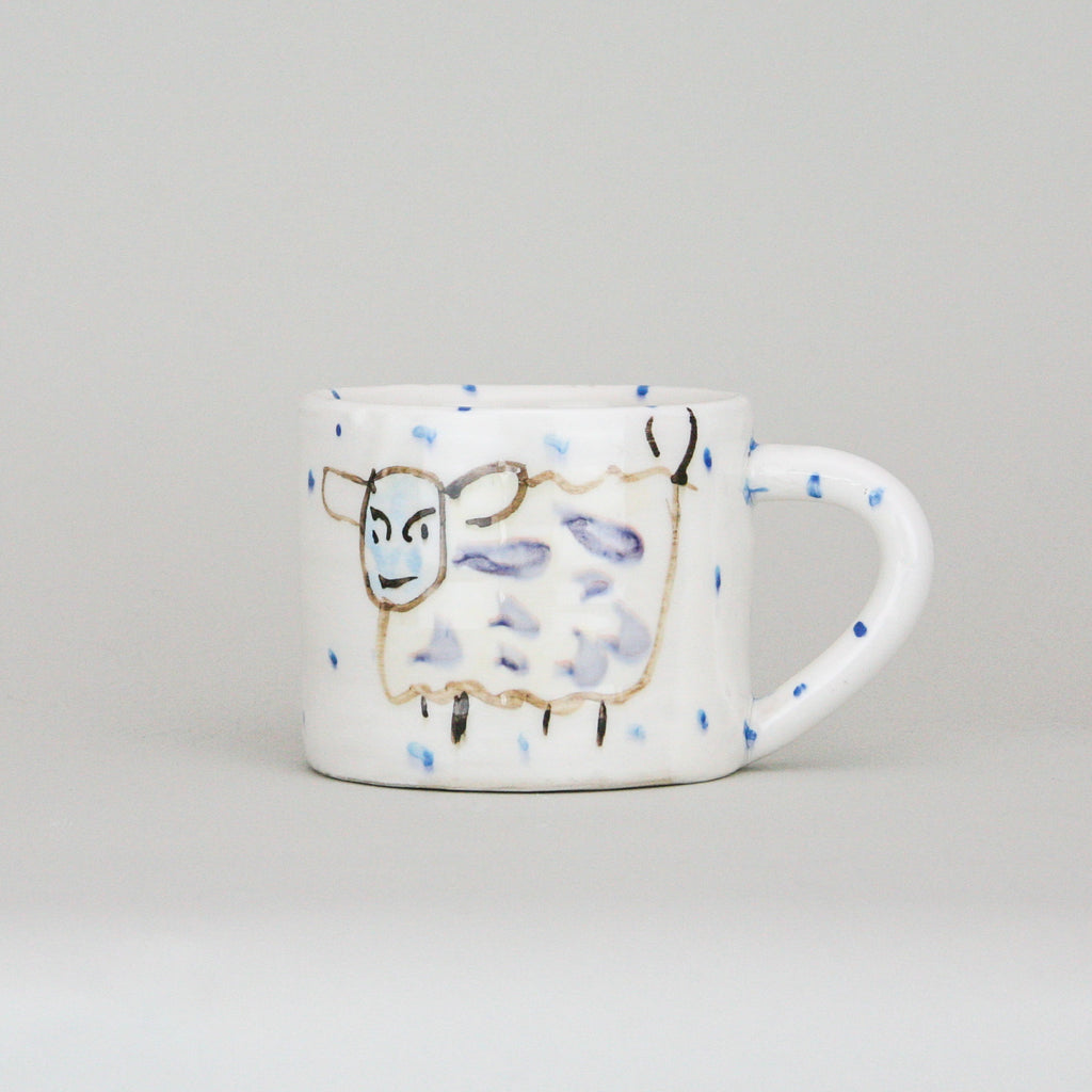 Large Irish Ceramic Pottery Mug with hand painted Witty Sheep Design with peridoc blue dots on a luxurious white background