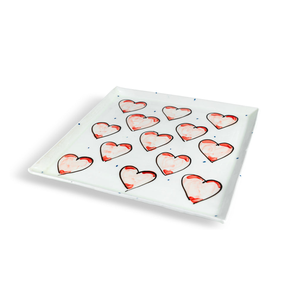 Large square plate with Grá heart patterns on a luxurious white background with periodic blue dots