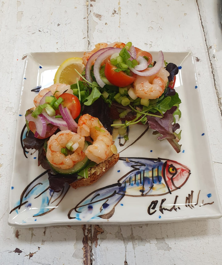 Medium square Irish pottery dinner plate with a hand-painted mackerel fish. This ceramic pottery dish is peppered with little blue dots. Handmade in Ireland. Perfect for mains or starters!