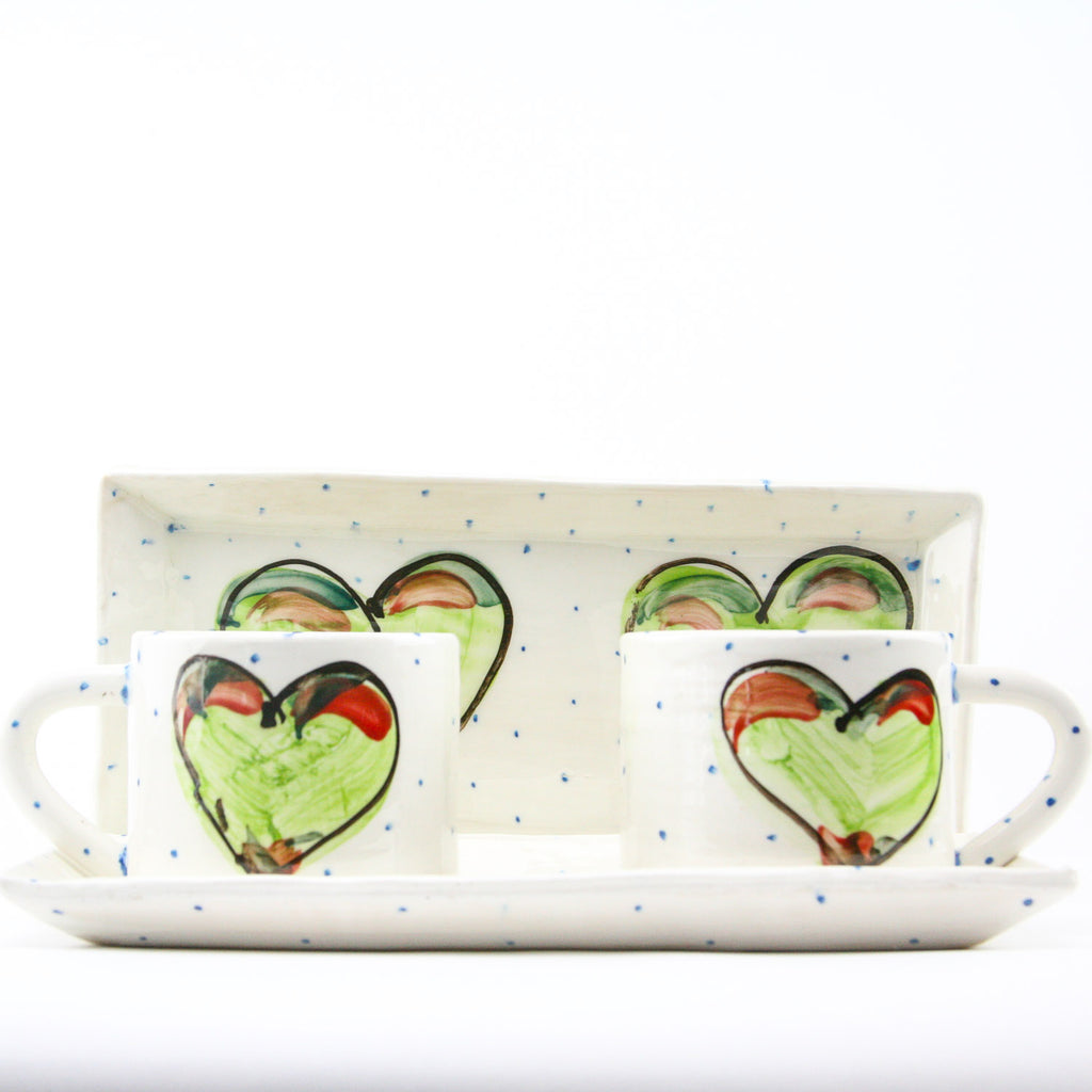 The Green Heart Small Rectangular Platter is handmade using white earthenware clay, individually hand painted, signed and fired twice by Charlie Mahon here in our pottery in Cork, Ireland. Shown here with two of our mugs (not included with the individual platter).