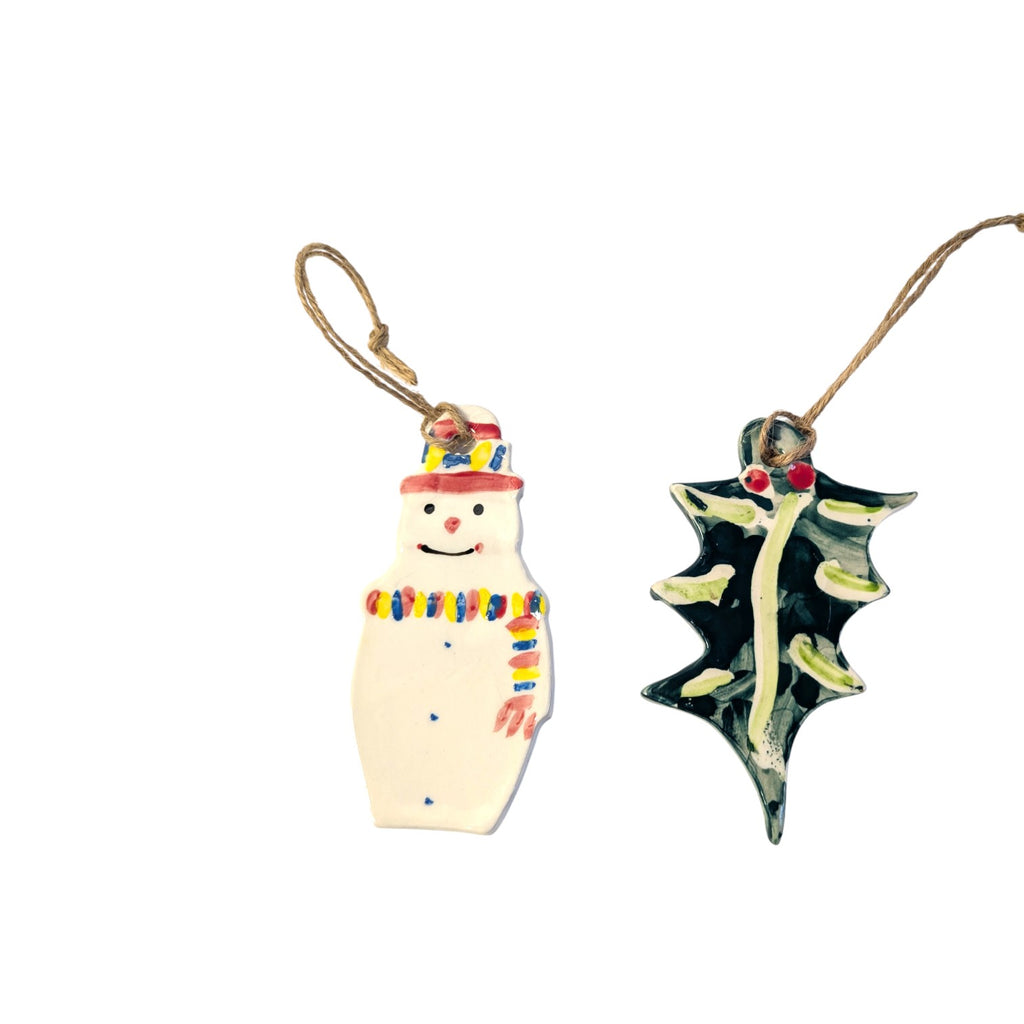 Two Christmas Decorations on a white background in Snowman Christmas Baubles and Holly Christmas Baubles