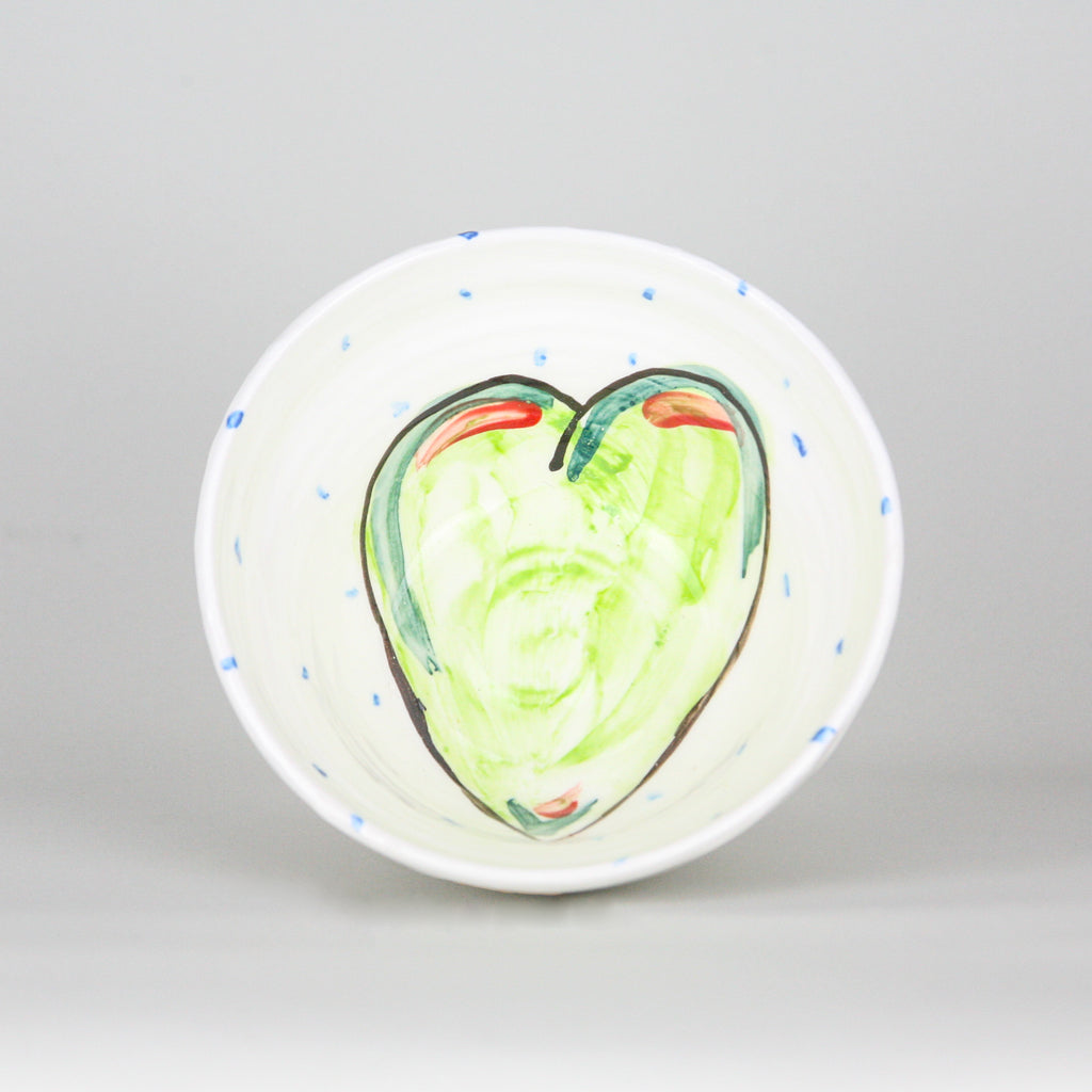 White ceramic pottery bowl with blue hand-painted dots and green heart. Handmade in Ireland.
