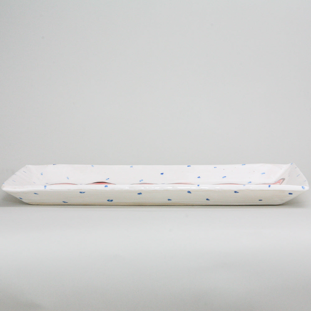 Rectangular platter. White pottery peppered with blue dots and hand-painted with red hearts. Handmade in Ireland.