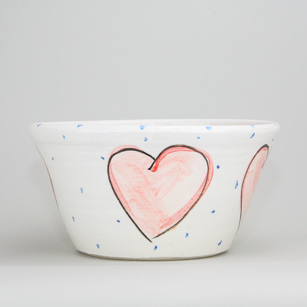Large white ceramic bowl hand-painted with red hearts adorned with a black outline on this Irish pottery. Little blue dots pepper the high gloss finish. Handmade in Ireland.