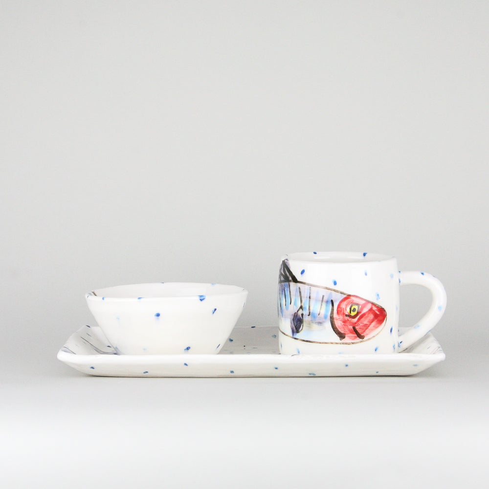 Mackerel fish rectangular platter and mug set. The mug sits on the right heart of the platter and handle facing right. Blue dots pepper the handmade Irish pottery. A ramekin bowl rests on the left side of the platter.