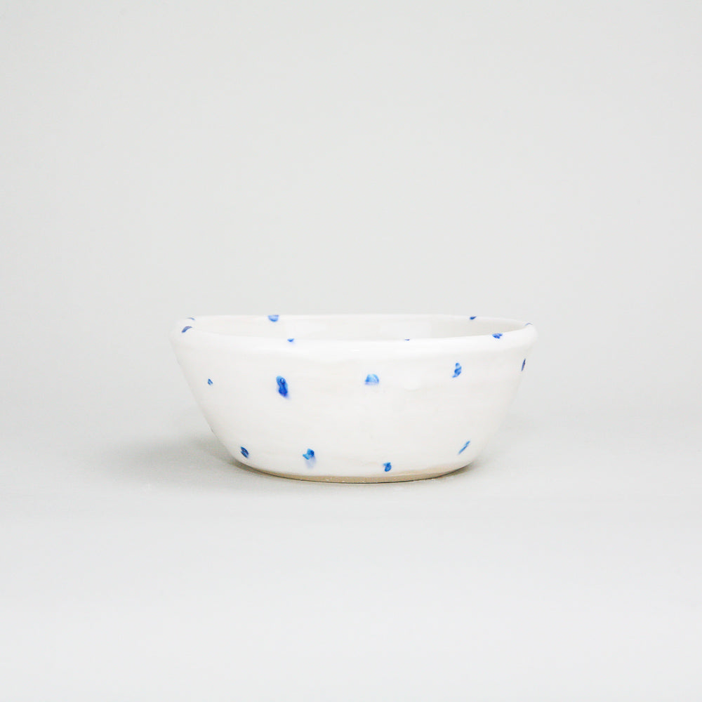 White ceramic pottery ramekin bowl with blue hand-painted dots. The centre of the bowl has a mackerel fish painted on it, but not visible in this photo. Handmade in Ireland.