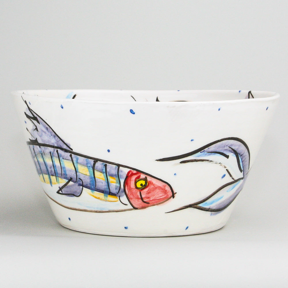 Large white ceramic bowl hand-painted with mackerel fish on this Irish pottery. Little blue dots pepper the high-gloss finish. Handmade in Ireland.