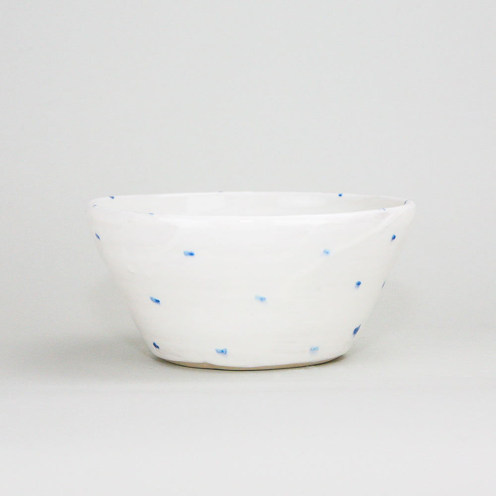White ceramic pottery ramekin bowl with blue hand-painted dots. The centre of the bowl has a sheep painted on it, but not visible in this photo. Handmade in Ireland.